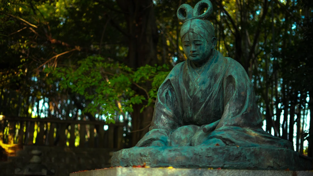 Statue of lone maiden in shrine near Inari Fushimi Taishi Kyoto, Japan