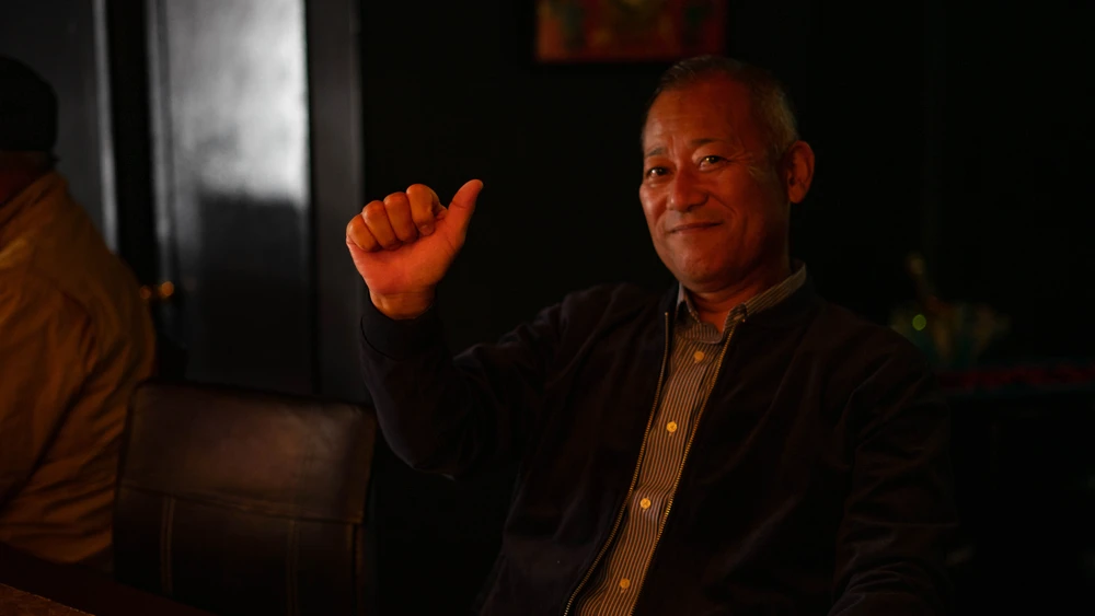 Happy man with thumbs up in Jacqueline bar in downtown Takamatsu, Japan