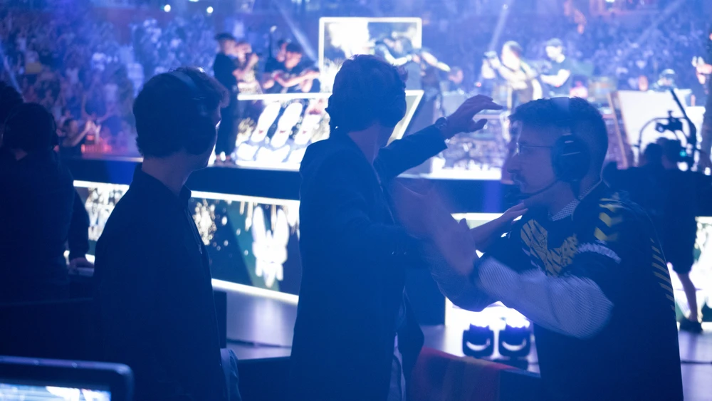 Three presenters reacting at Team Vitality winning the finals at RLCS Worlds Cologne 2023, Germany